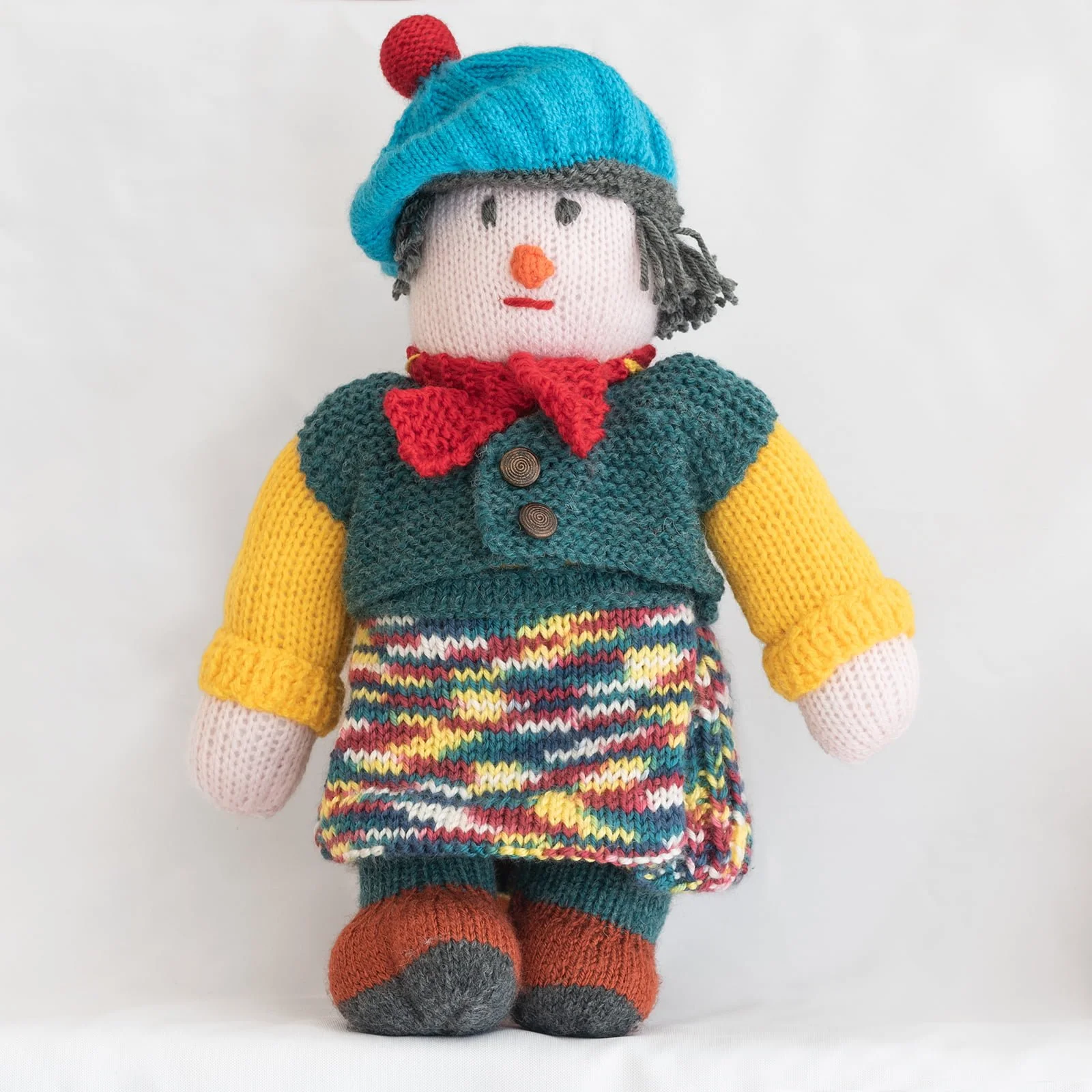 hand knitted Scottish character with multi colour kilt