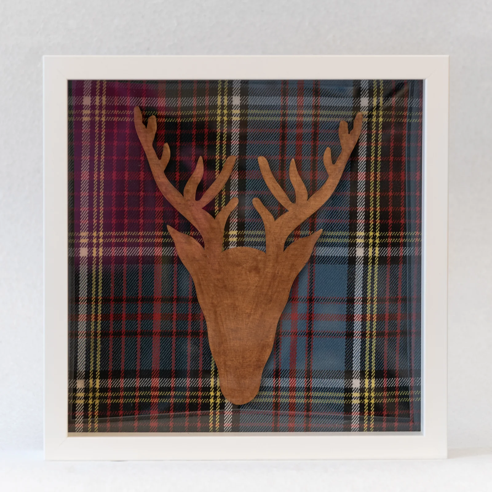 wooden stag head on tartan background picture