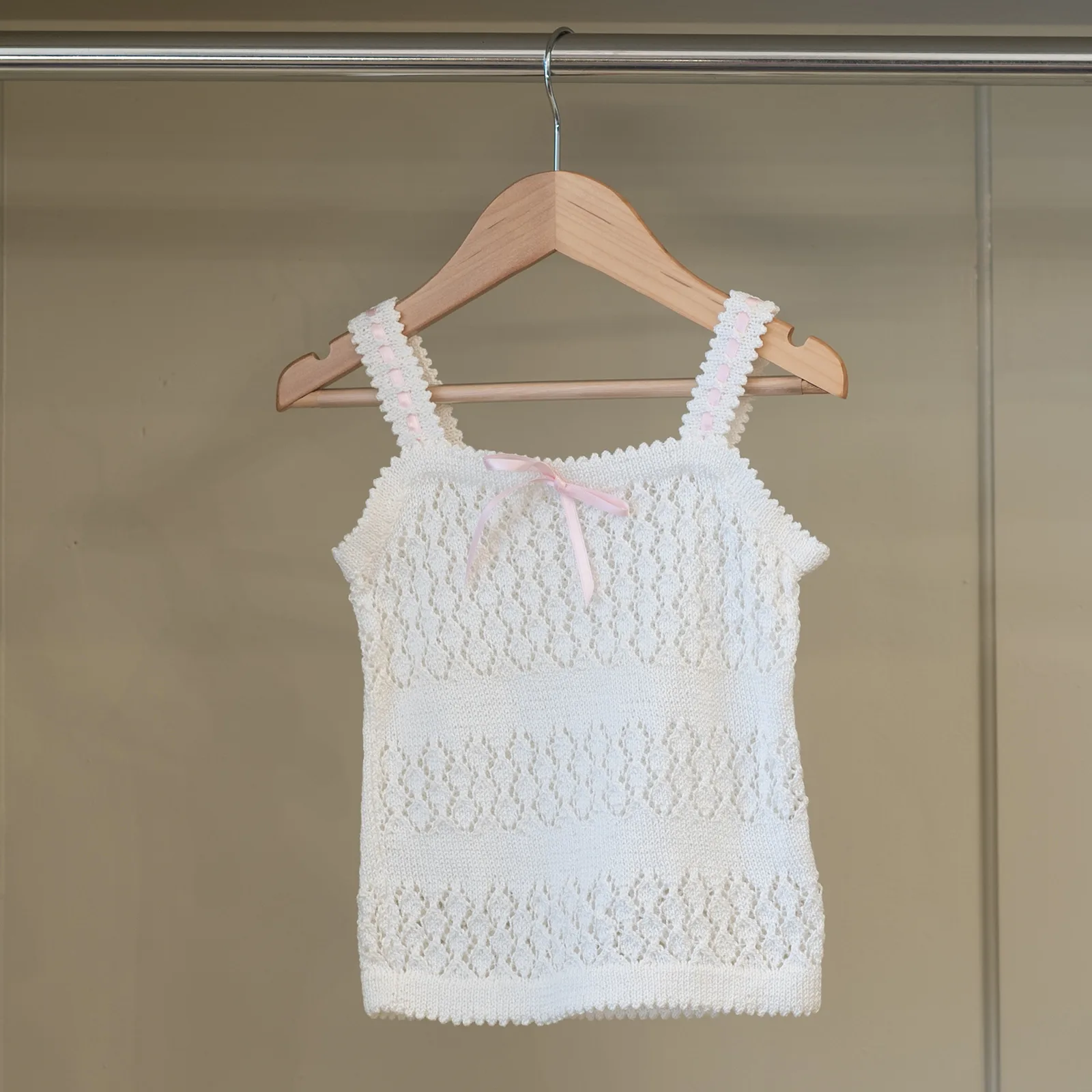 hand knitted baby vest white with pink ribbon